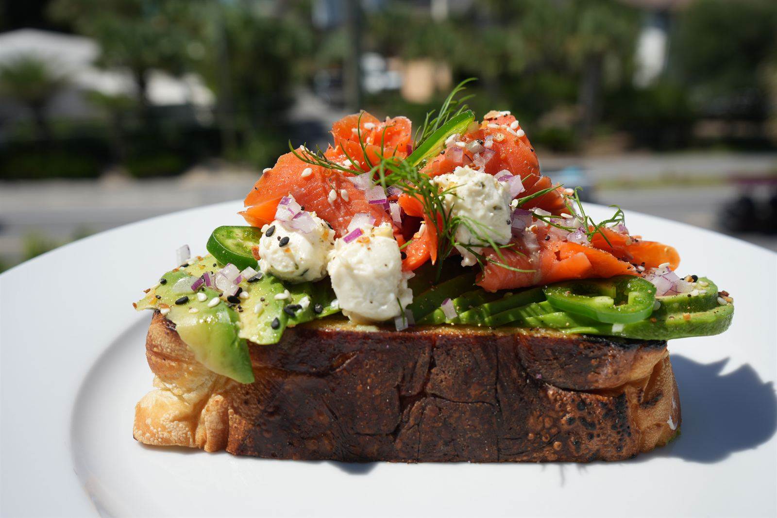 Smoked salmon and avocado toast with whipped cheese on sourdough