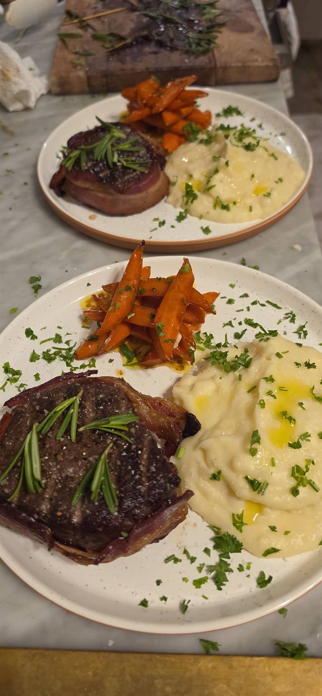 Bacon-wrapped filet mignon with glazed carrots and mashed potatoes