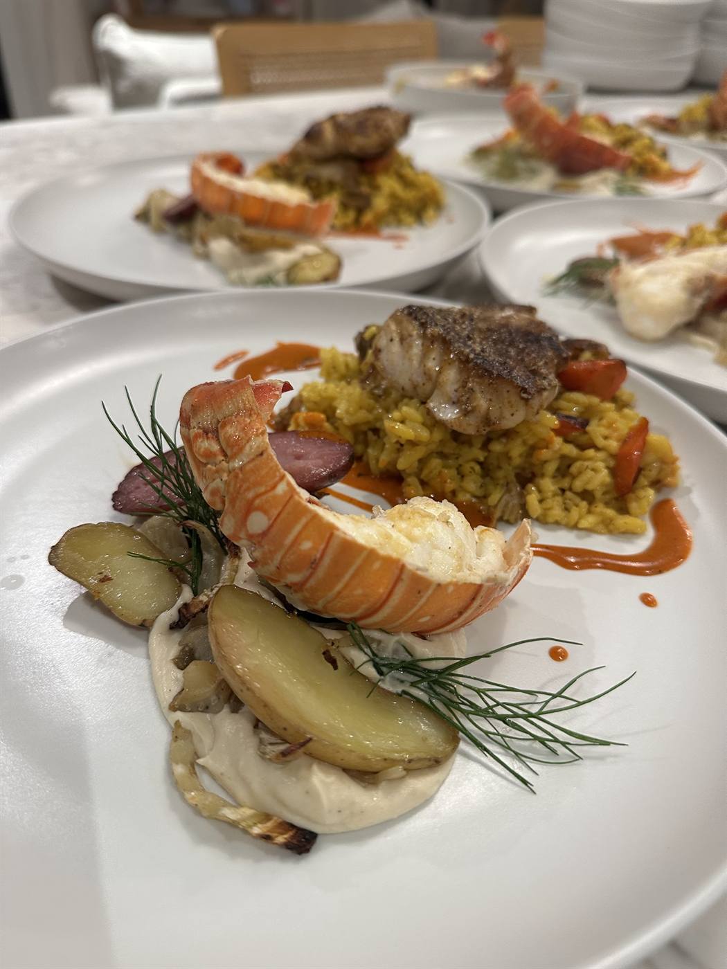 Butter-poached lobster tail over saffron risotto