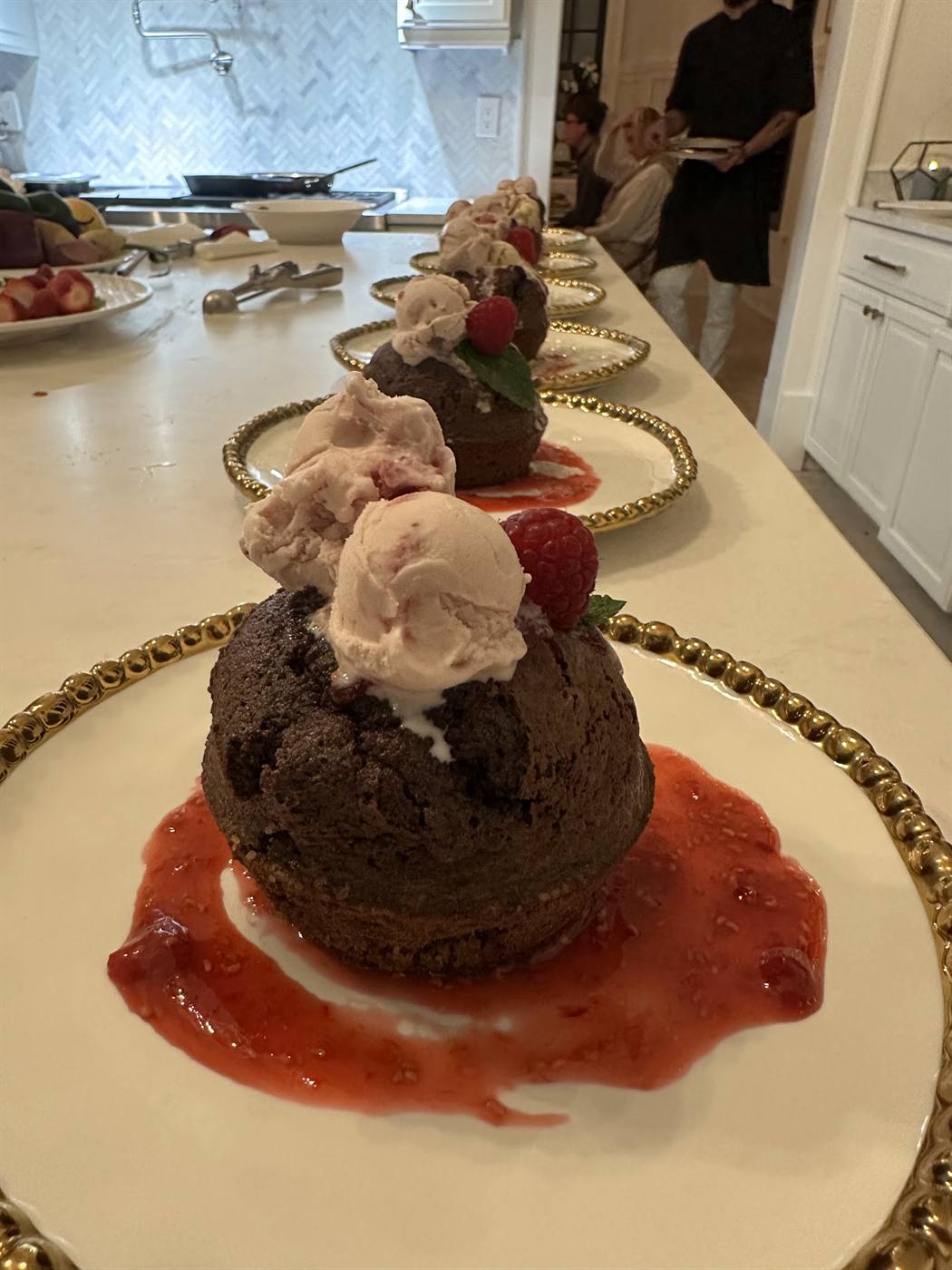 Flourless chocolate torte with whipped cream and a bright berry sauce