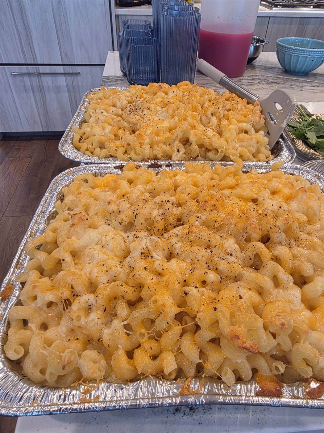 Trays of baked mac and cheese with a golden top