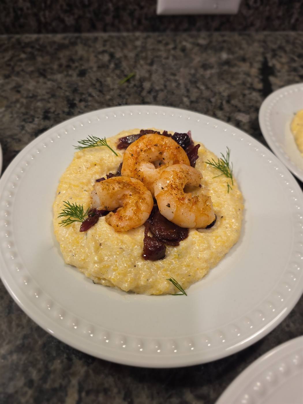 Stone-ground cheese grits topped with seared Gulf shrimp