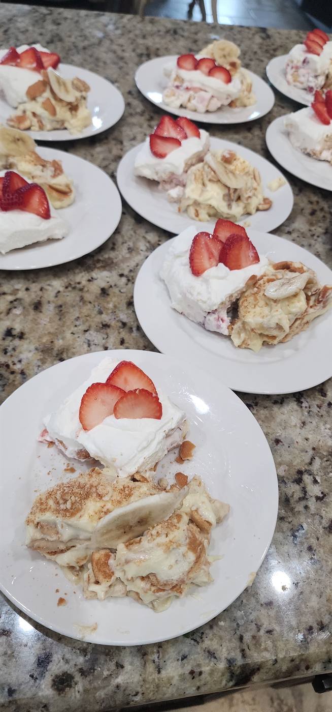 Slices of tres leches cake with whipped cream and fresh strawberries